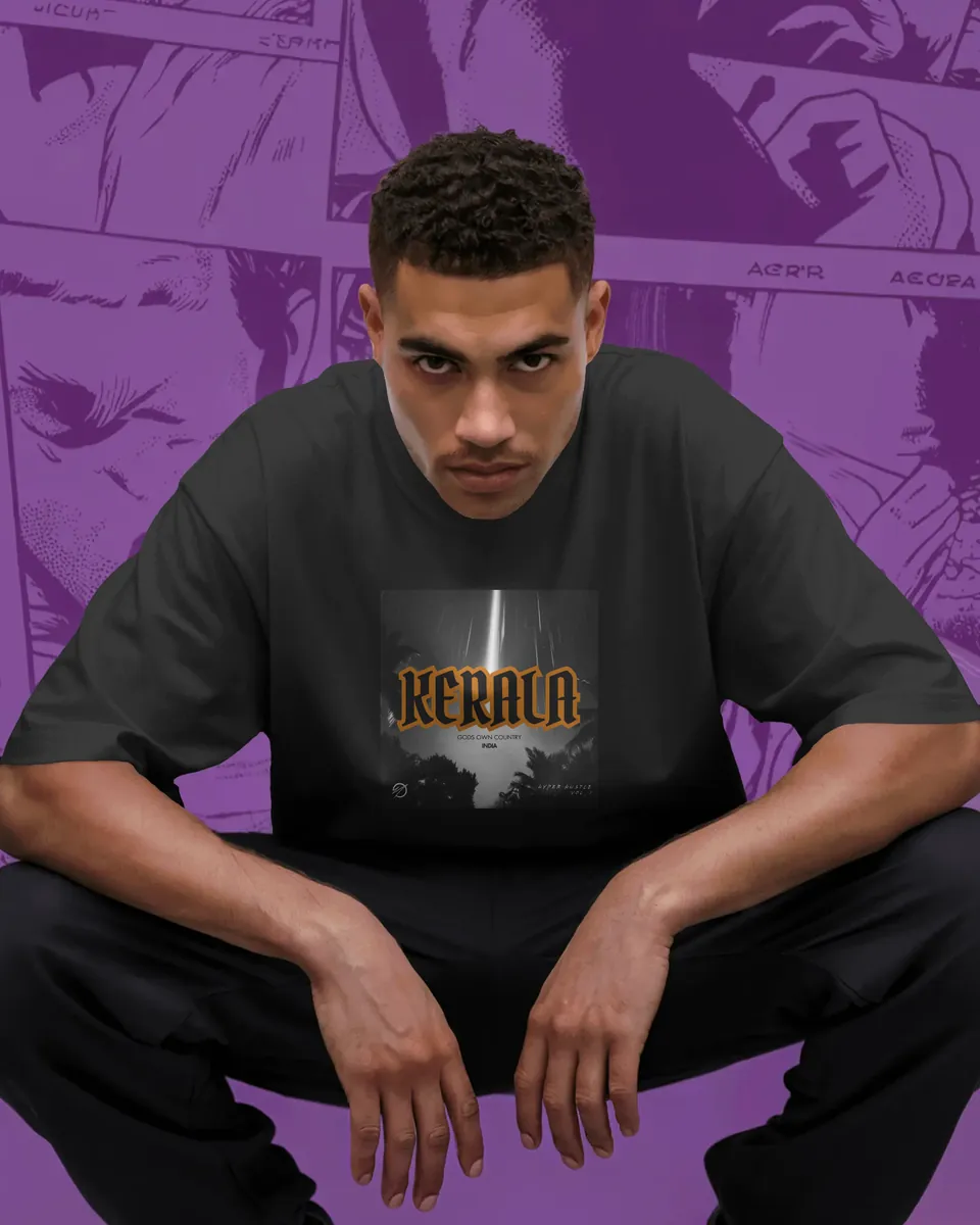 Model crouching in the black Kerala oversized t-shirt